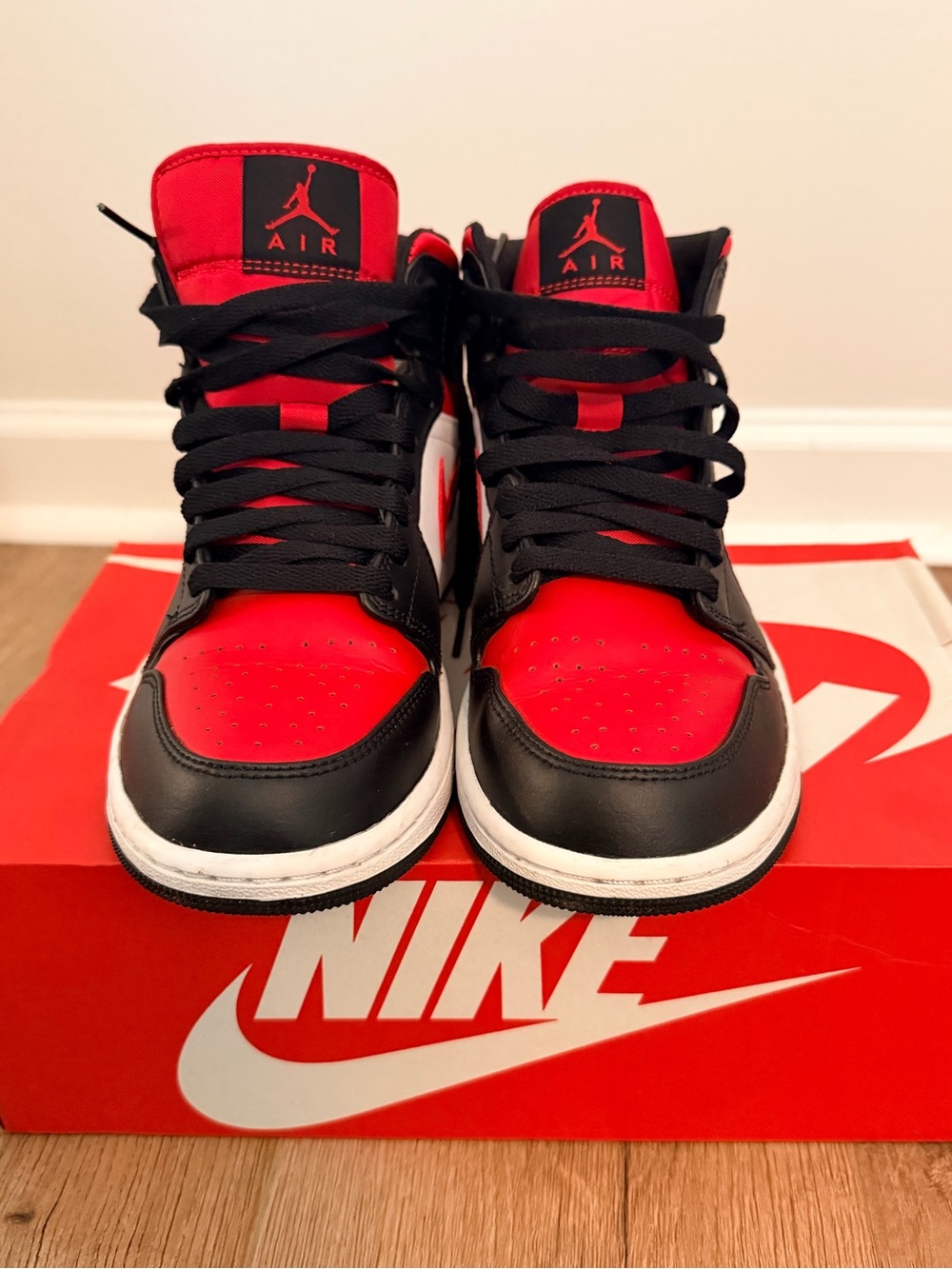 Jordan 1’s Mid Sneakers in Black/Red